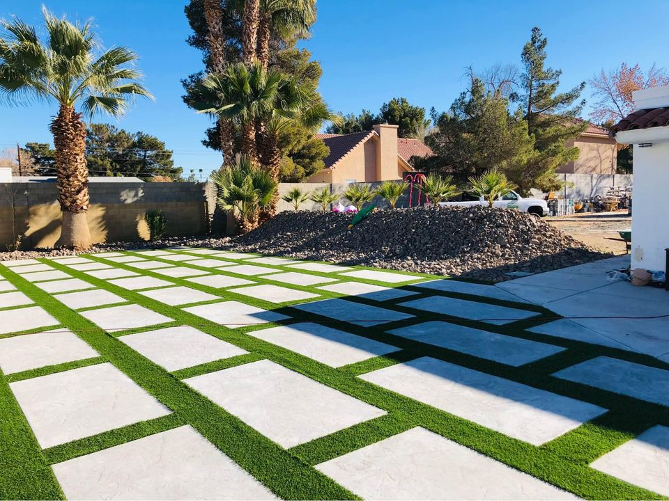 Freshly poured and smoothed concrete slabs by expert concrete contractors form a large, flat surface in Riverside CA, divided into square sections with visible seams. The cement appears uniformly gray and reflective under daylight, indicating recent work completion.